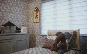 White blind fitted to a wide bedroom window above a bed