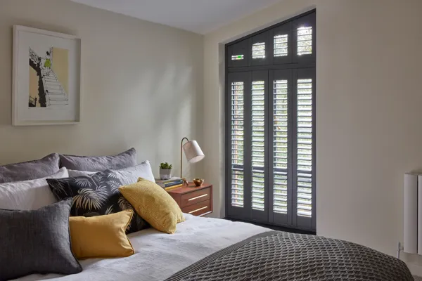 closed grey shutter on a slant shaped window in the Tebbutts bedroom