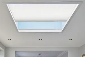 Close up of roof lantern window dressed in white duette blind partially open.