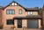 A family house with a jet black door, jet black window frames, and a jet black roller garage door.