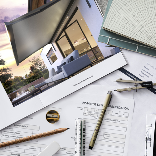Overhead shot of awnings booklet and technical drawing equipment and paperwork.