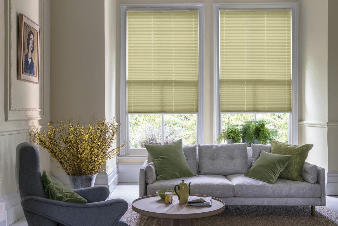 ivory Pleated blinds have been fitted to multiple windows in a luxuriously styled kitchen in marble and white. Parchment Eggshell Crush has a plain style that complements the room.