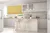 Bifold doors reveal kitchen in white tongue and groove with matching island and high wood stools and wide window dressed in mustard yellow roller blind with wave pattern.