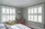 white vinyl shutters in two bedroom windows on adjacent walls 