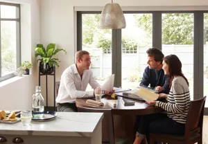 a thomas sanderson advisor having a face to face consultation with two customers in their home