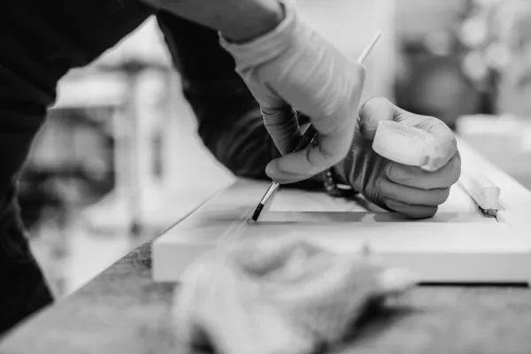 close up of employee applying finishing touches to a shutter