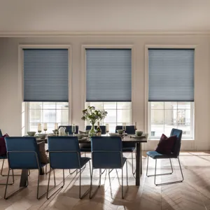 light blue blinds in three identical large windows in a large dining room with a brown table and eight blue chairs