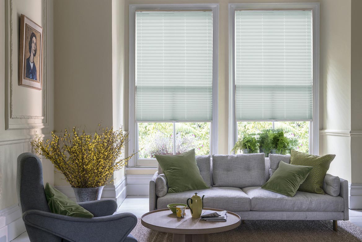 duck egg Pleated blinds have been fitted to multiple windows in a luxuriously styled kitchen in marble and white. Tosca Soft Mint has a stripe style that complements the room.