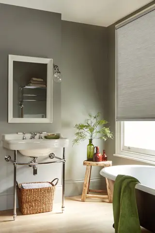 grey duette blinds fitted to a window in a bathroom