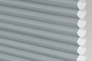 Close up of a pale grey micro hive honeycomb blind.