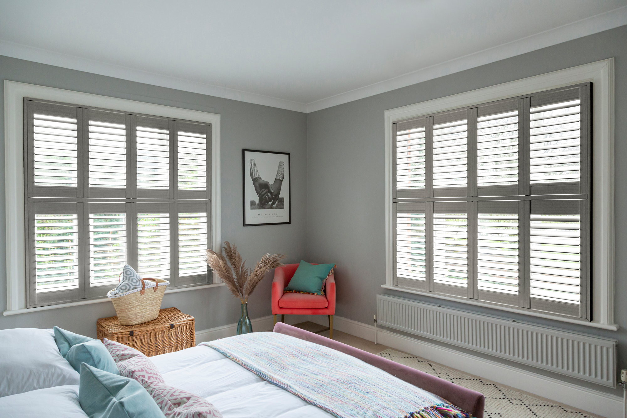 Heritage ash light grey shutters fitted to two windows in a grey decorated bedroom